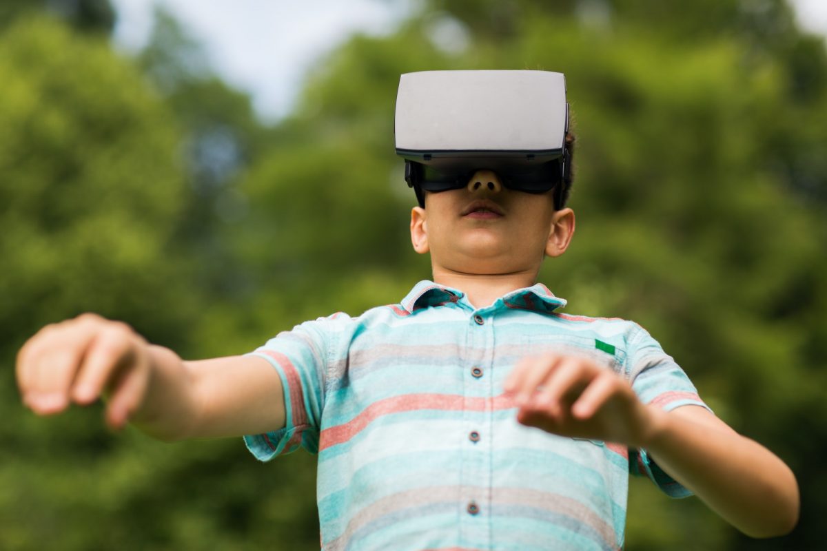 boy with virtual reality headset outdoors